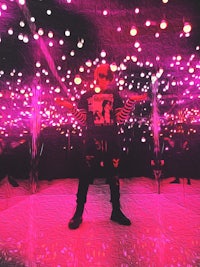 a person standing in front of a room full of lights